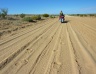Dragging the bike through the sandy patches